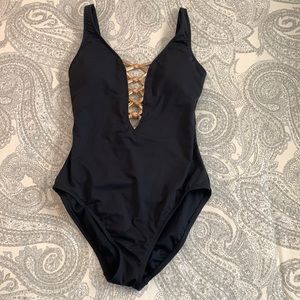Black one-piece with gold accents